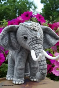 Handmade amigurumi crochet elephant with big floppy ears and soft trunk, made with grey and pink yarn. Elephant Crochet Pattern Free 