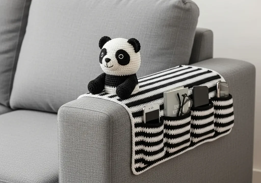 Crochet Sofa Arm Organizer Pattern with black and white stripes and a panda amigurumi