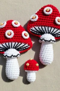 Crochet mushroom applique pattern made with worsted weight yarn in red and cream colors