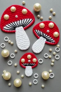Crochet mushroom applique pattern made with worsted weight yarn in red and cream colors