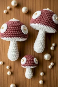 Crochet mushroom applique pattern made with worsted weight yarn in red and cream colors